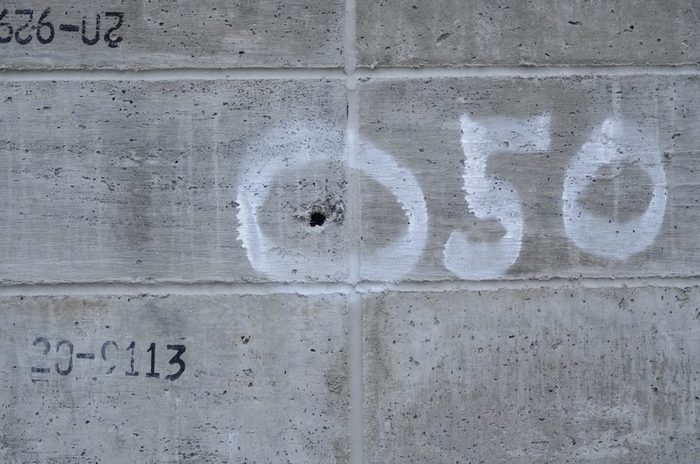 An Amidon Shield wall marked with .50 caliber impact points after testing