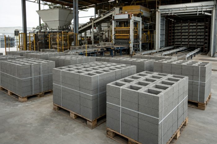 Pallets of finished concrete masonry units banded on a block production line