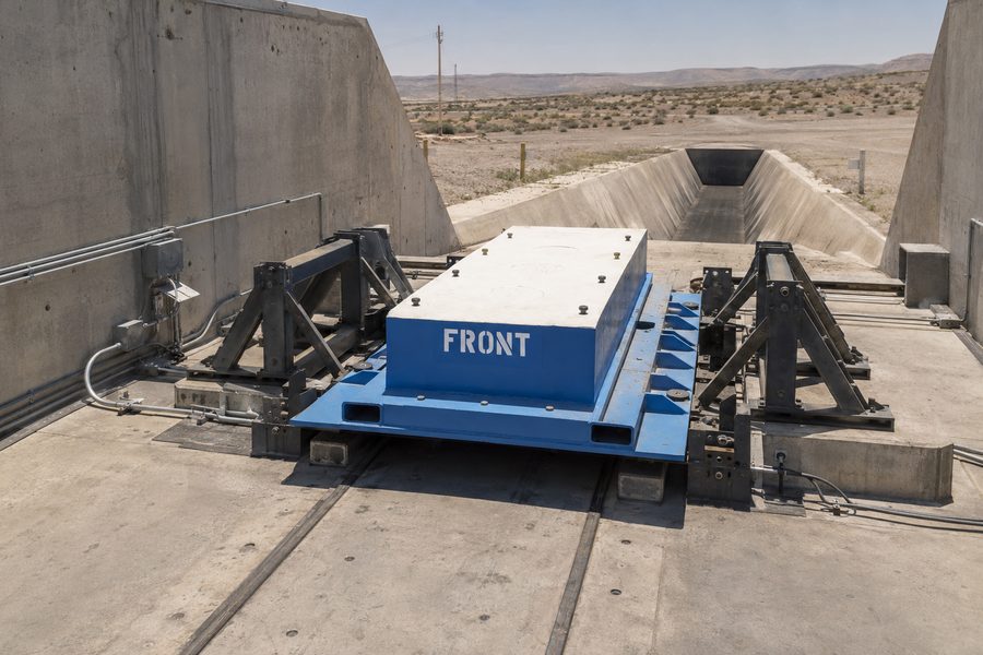 Reinforced concrete rocket motor test stand with exhaust trench